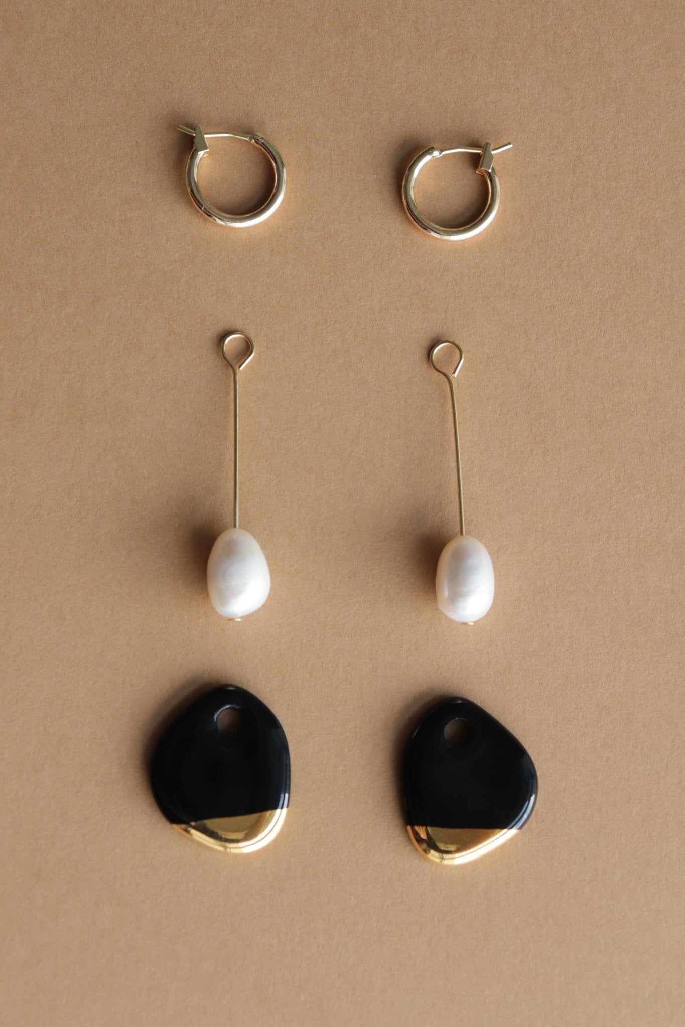 5. Flat lay of Rozenthal Arp Pearl and Porcelain Earrings components, including hoops, pearls, and porcelain