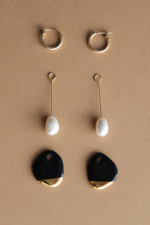 5. Flat lay of Rozenthal Arp Pearl and Porcelain Earrings components, including hoops, pearls, and porcelain