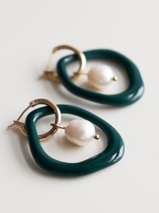 6. Studio image of Rozenthal Arp Pearl and Porcelain Hoops in green with freshwater pearls and gold-plated hoops