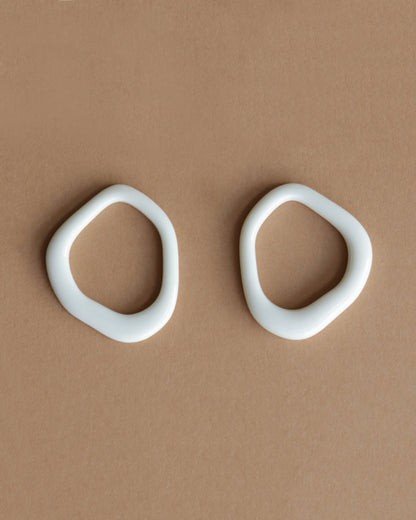 10. Close-up of Rozenthal Arp Pearl and Porcelain Hoops in burgundy, featuring freshwater pearls and gold-plated hoops