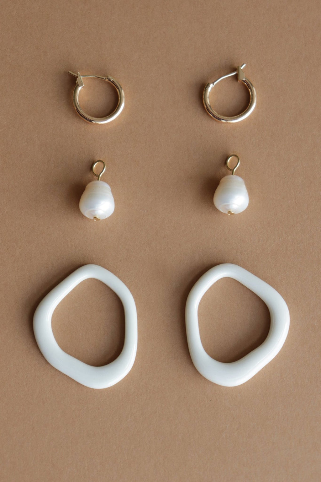 12. Flat lay of white porcelain elements and gold-plated hoops for Rozenthal Arp Pearl and Porcelain Hoops