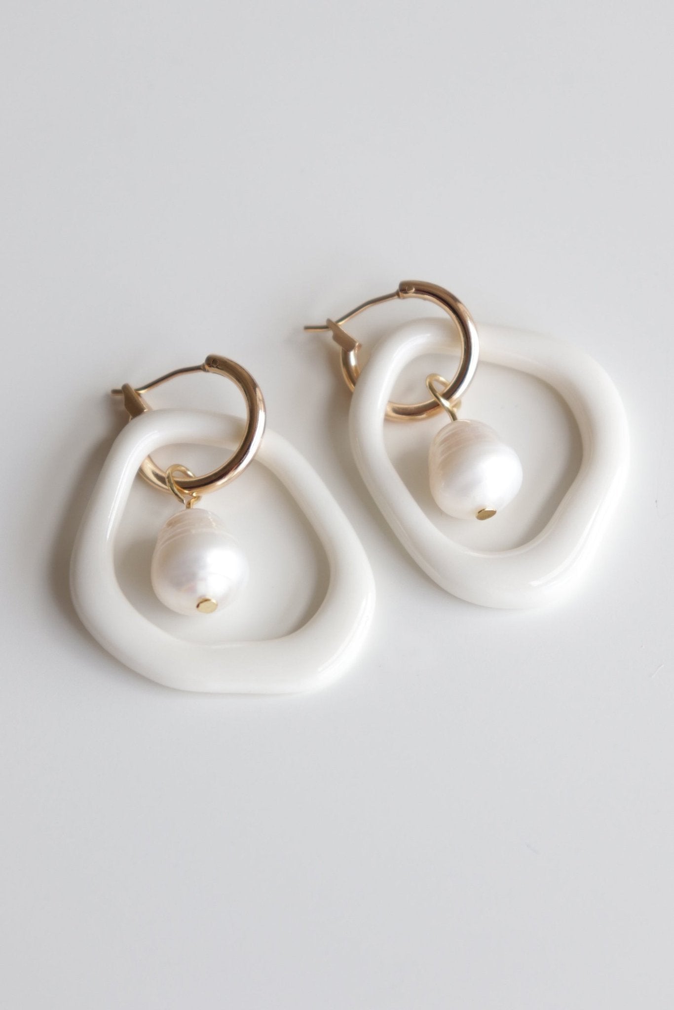 14. Rozenthal Arp Pearl and Porcelain Hoops in white with freshwater pearls, studio shot