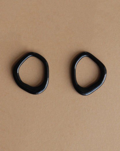 7. Flat lay of black porcelain elements for Rozenthal Arp Pearl and Porcelain Hoops