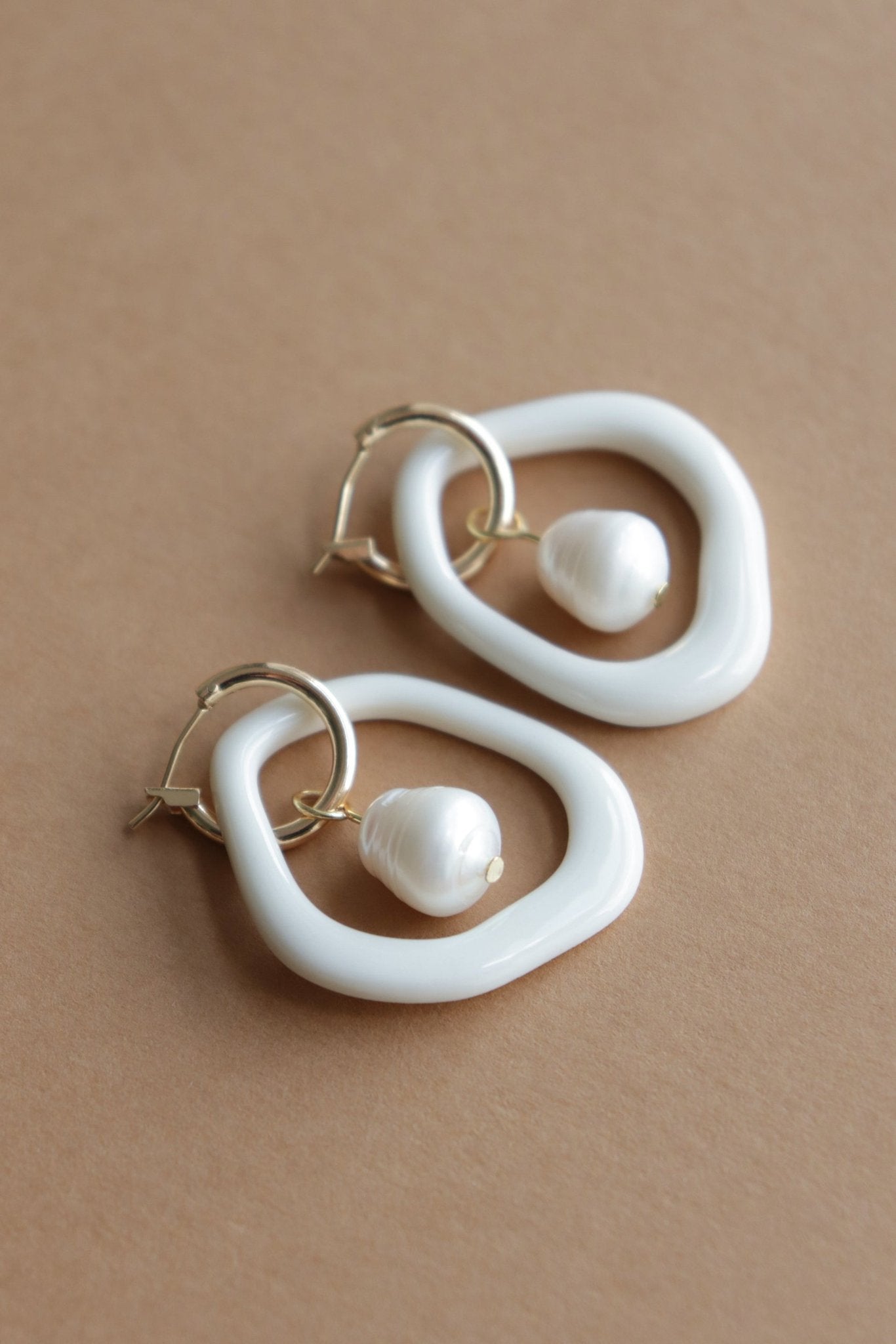 16. Rozenthal Arp Pearl and Porcelain Hoops in white with freshwater pearls, studio shot