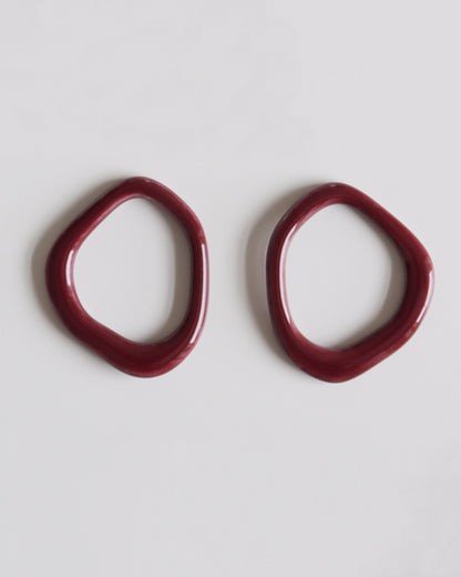6. Flat lay of burgundy porcelain elements for Rozenthal Arp Pearl and Porcelain Hoops