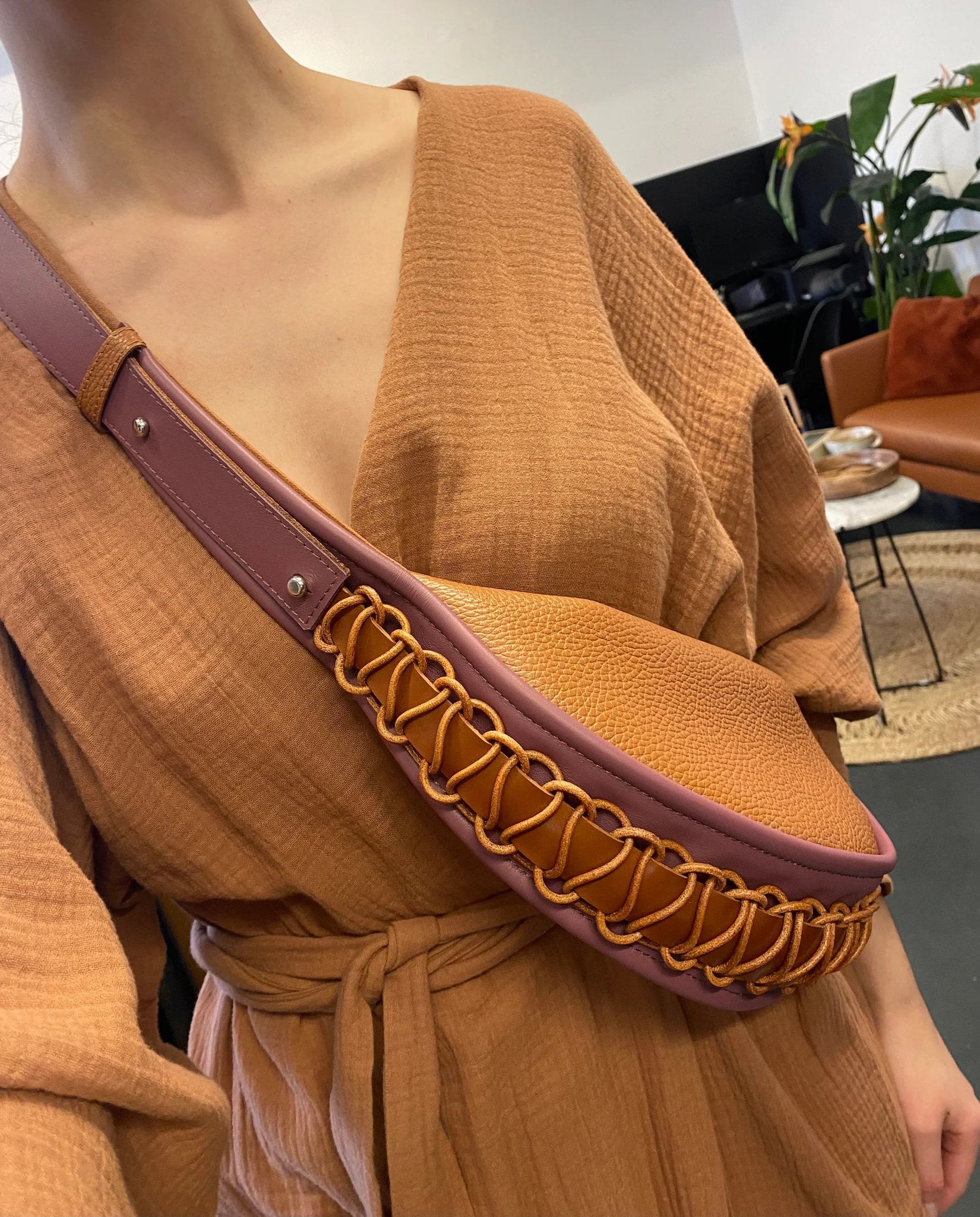 2. Woman wearing Gerda Retter Design Leather Bag Ateena in caramel brown, styled with a matching outfit