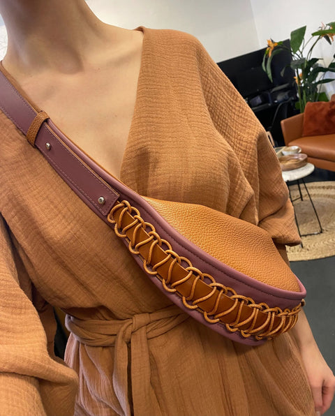 2. Woman wearing Gerda Retter Design Leather Bag Ateena in caramel brown, styled with a matching outfit