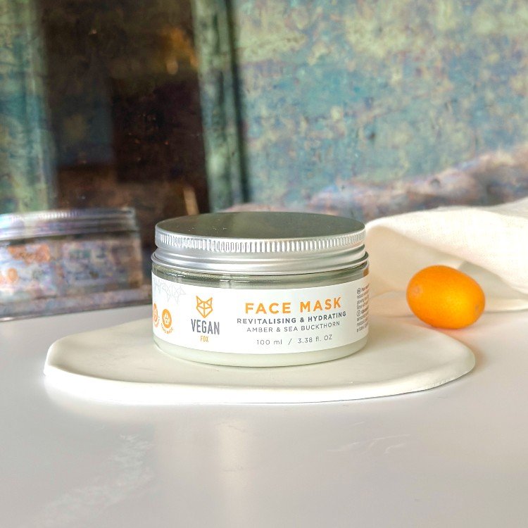 3. Vegan Fox Revitalising & Hydrating Face Mask jar on reflective surface with plants, 100 ml