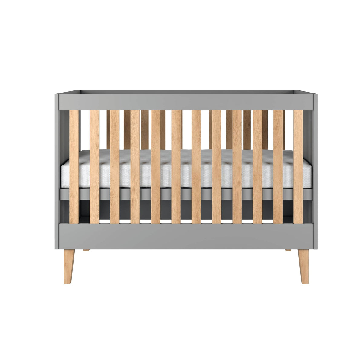 2. Front view of grey baby cot with oak slats and legs in studio setting, showcasing modern design
