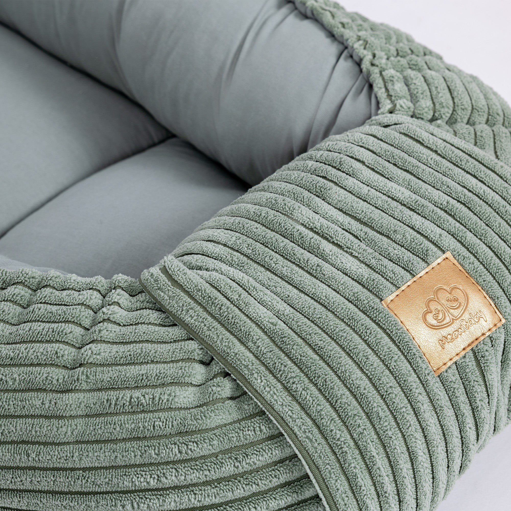 3. Close-up of MeowBaby logo on ribbed olive green fabric of baby nest