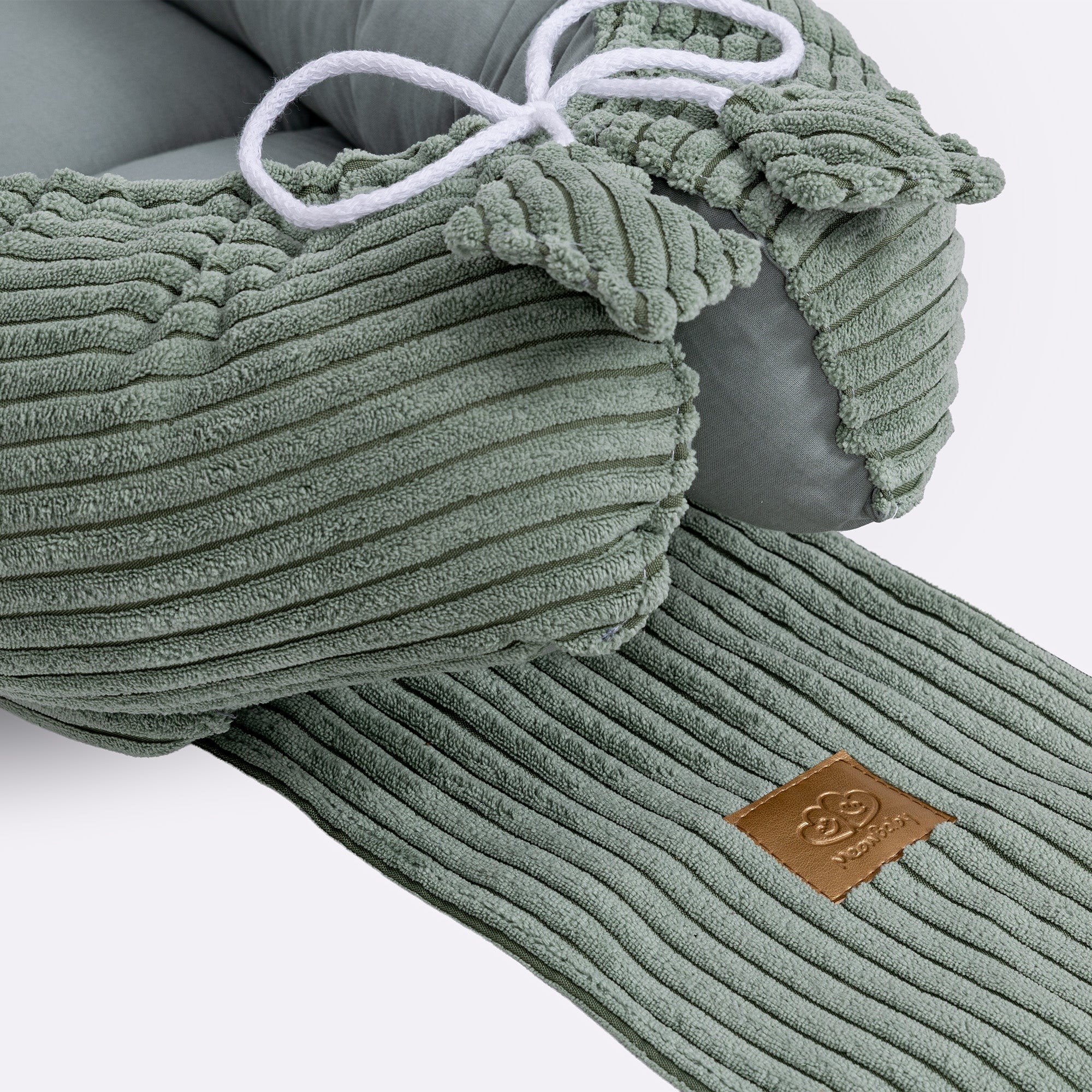 3. Close-up of olive green baby nest showing ribbed texture and drawstring detail