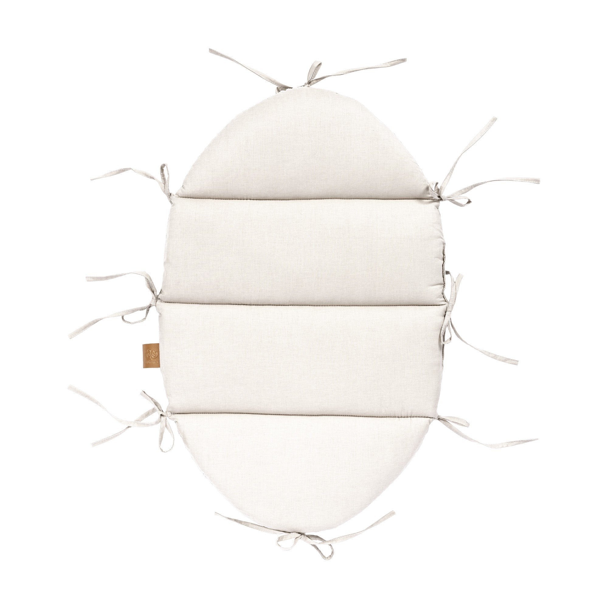 2. Flat lay of vanilla baby nest mat with fabric ties, made from 100% cotton, showing attachment points
