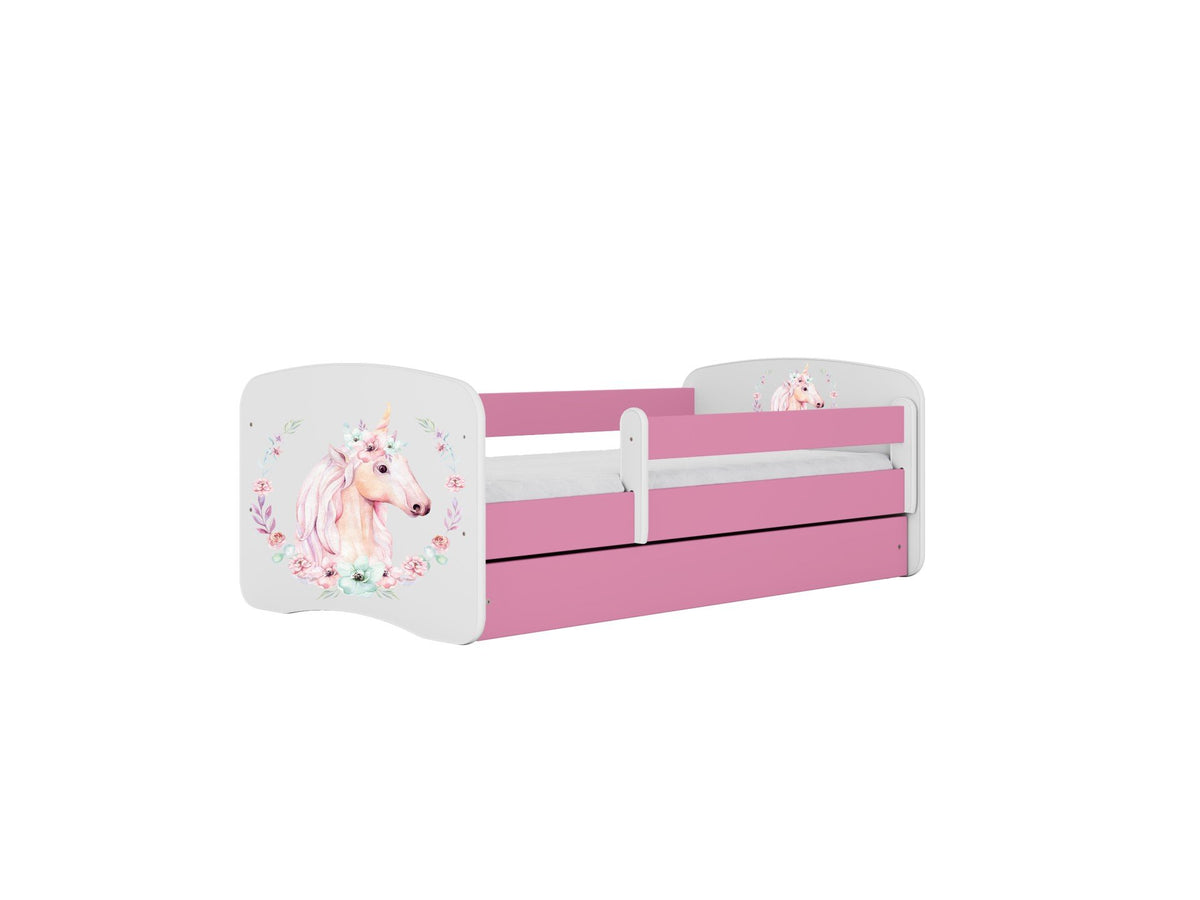 6. Pink and white children's bed with unicorn design and guardrail, featuring floral accents, shown with closed drawer