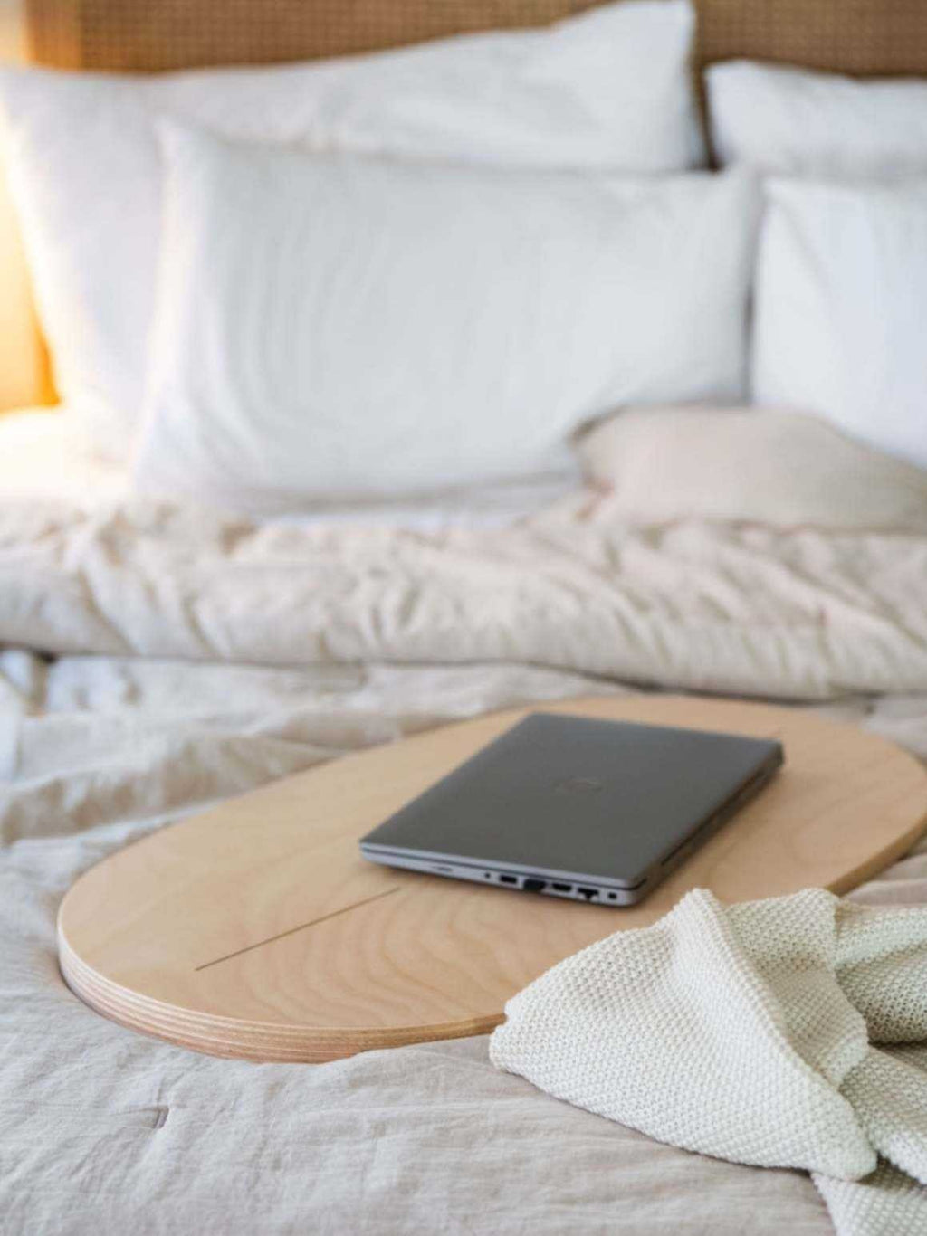 4. Flat lay of balance board used as laptop desk on bed with pillows