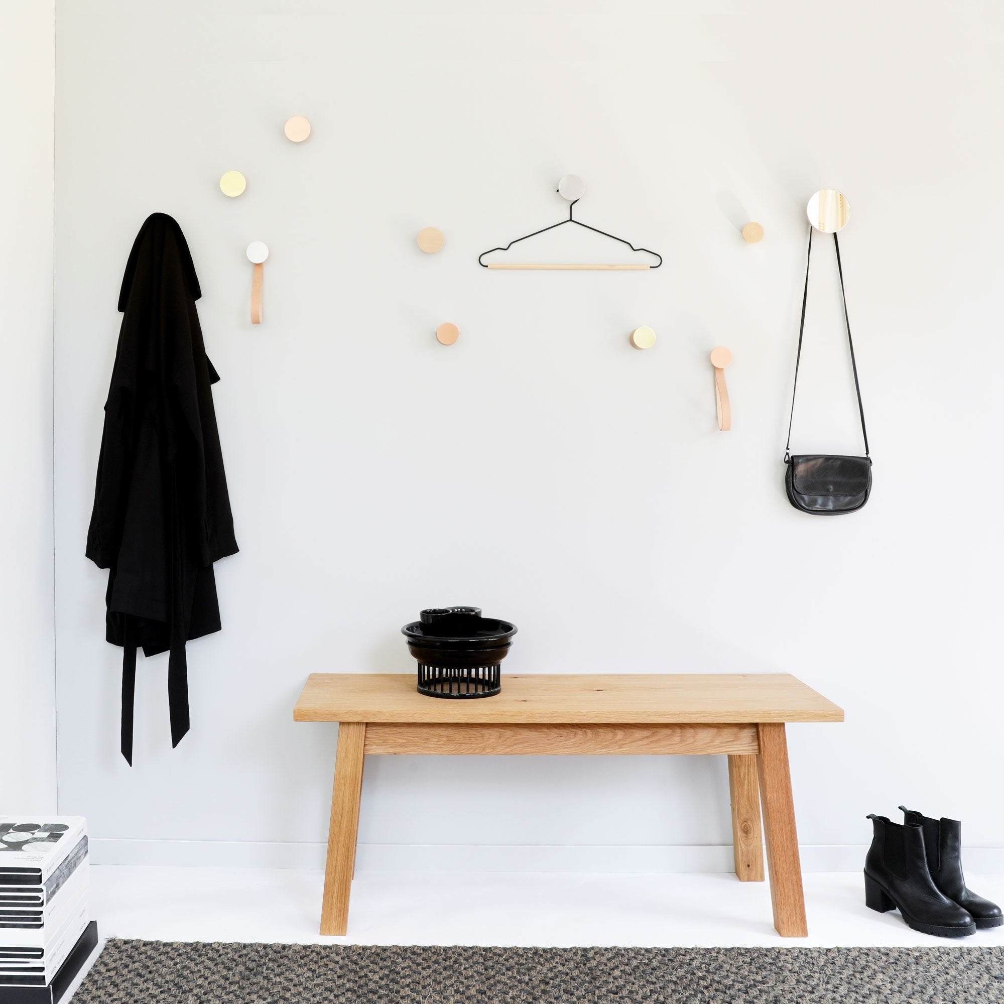1. Lifestyle image of Beech Wood & Copper Wall Hooks by 5mm Paper, used for coats and bags in a modern room setting