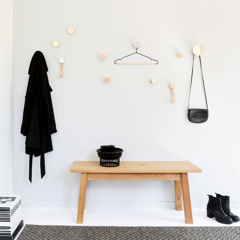 1. Lifestyle image of Beech Wood & Copper Wall Hooks by 5mm Paper, used for coats and bags in a modern room setting