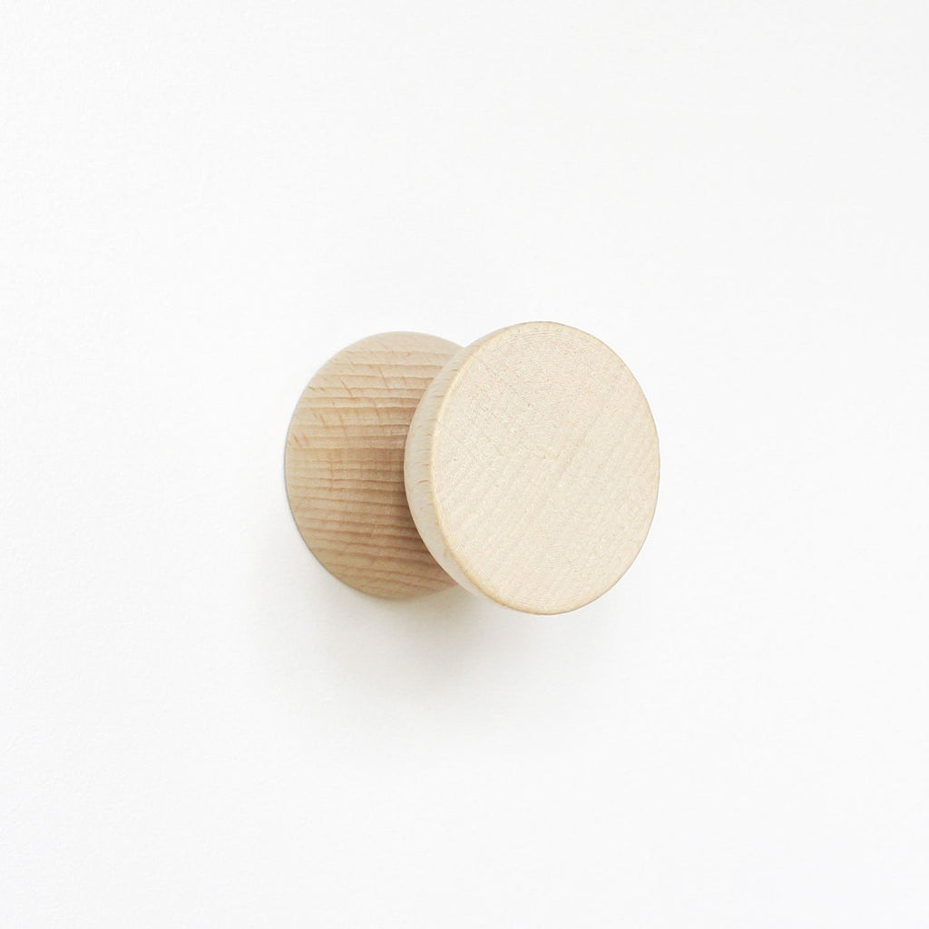 6. Close-up of a single beech wood wall hook by 5mm Paper showing wood grain and finish