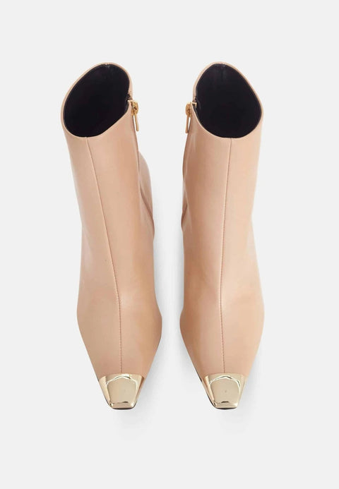 3. Top view of beige calf leather ankle boots with pointed toe and metallic tip, highlighting design and side zip