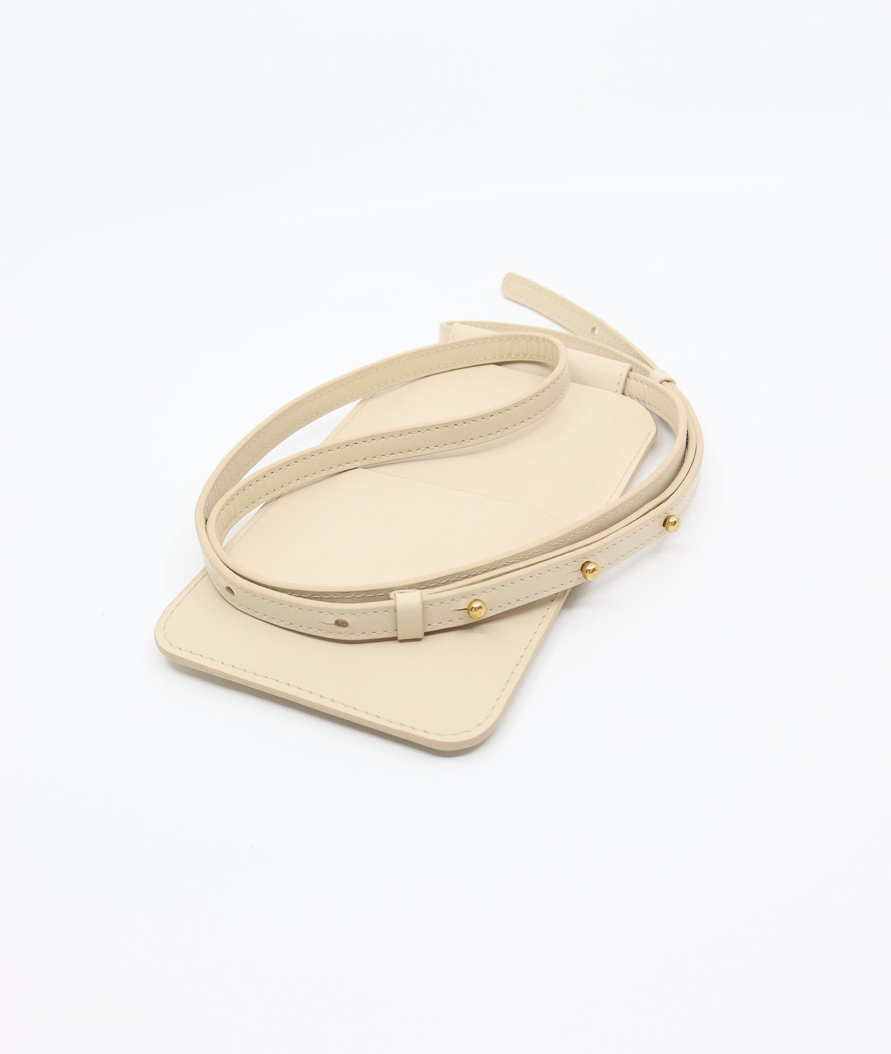 4. Close-up of Tairi Roosve beige leather phone bag with gold Sam Browne buttons and adjustable strap
