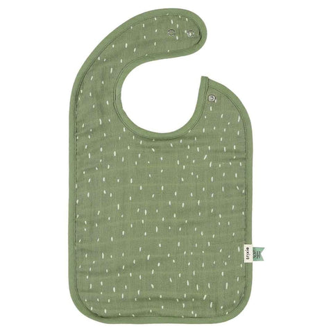 4. Trixie Baby bib in dark green muslin with white speckled pattern and adjustable snaps, shown on a white background