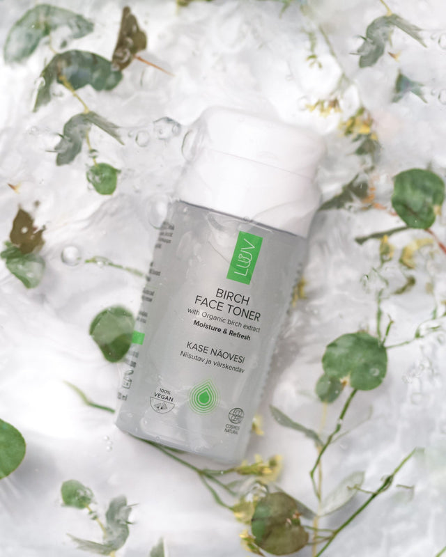 1. LUUV Birch Face Toner bottle with organic birch extract on a watery background with green leaves
