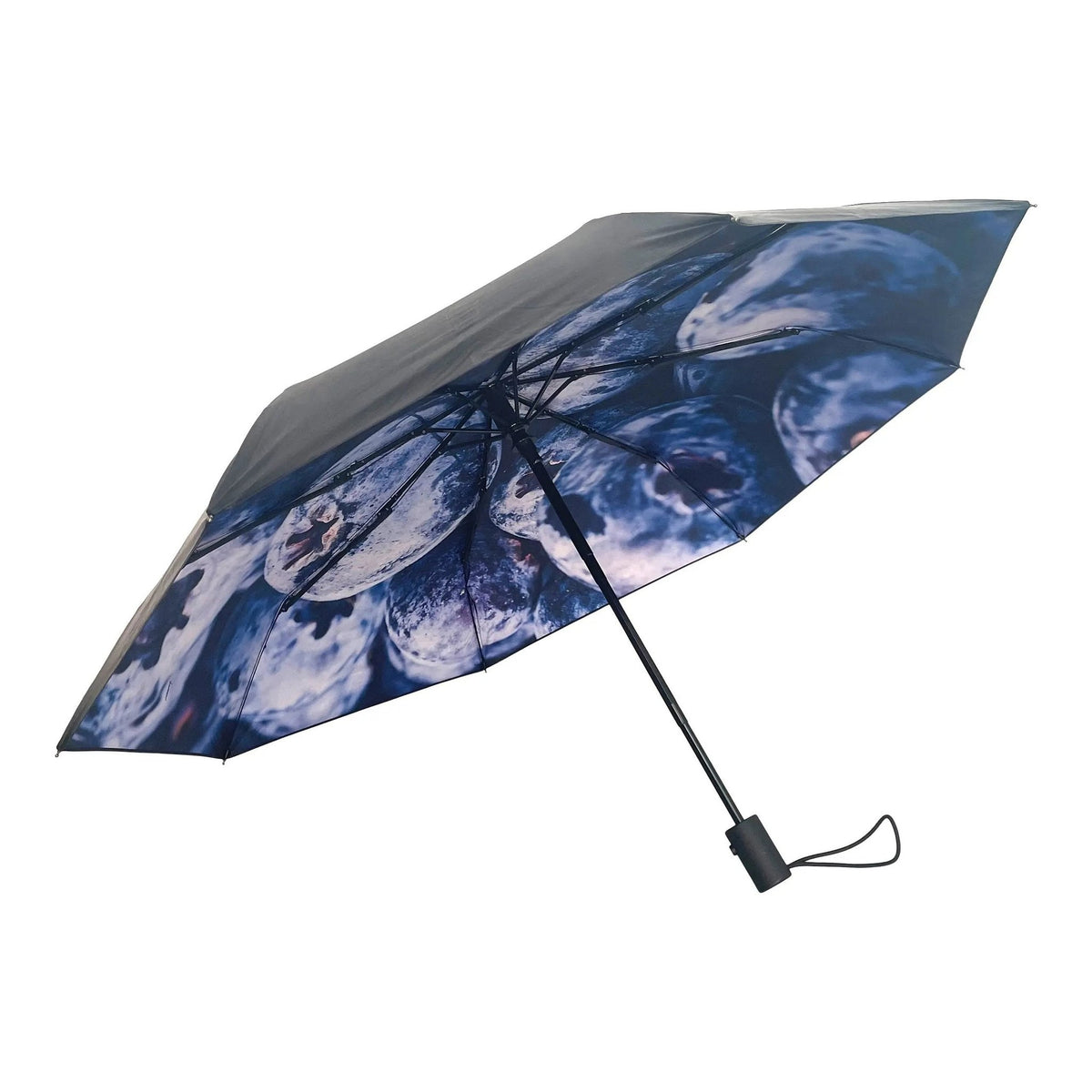 2. Blåbär umbrella with blueberry print and black exterior shown open in studio setting