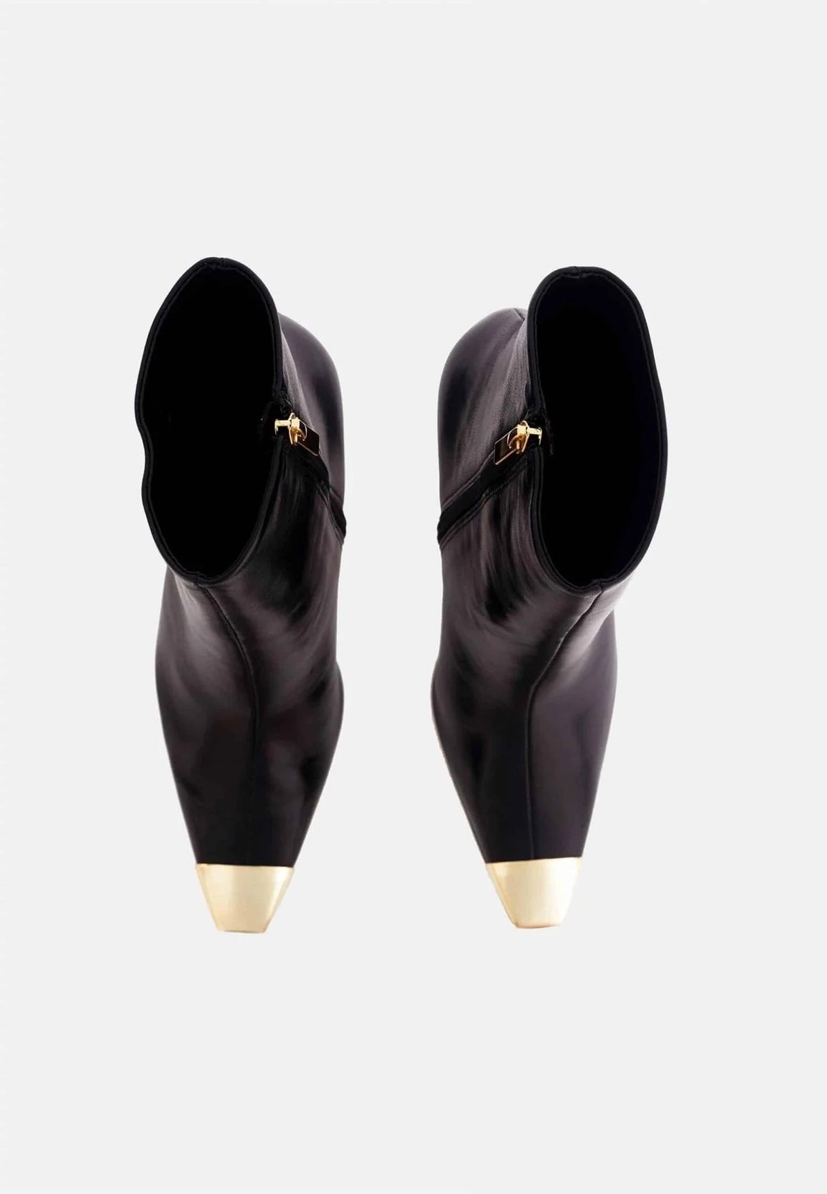 3. Top view of black calf leather ankle boots with gold pointed toes and side zips on white background