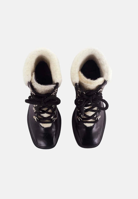 3. Top view of black calf leather combat boots with shearling lining and lace-up closure on white background