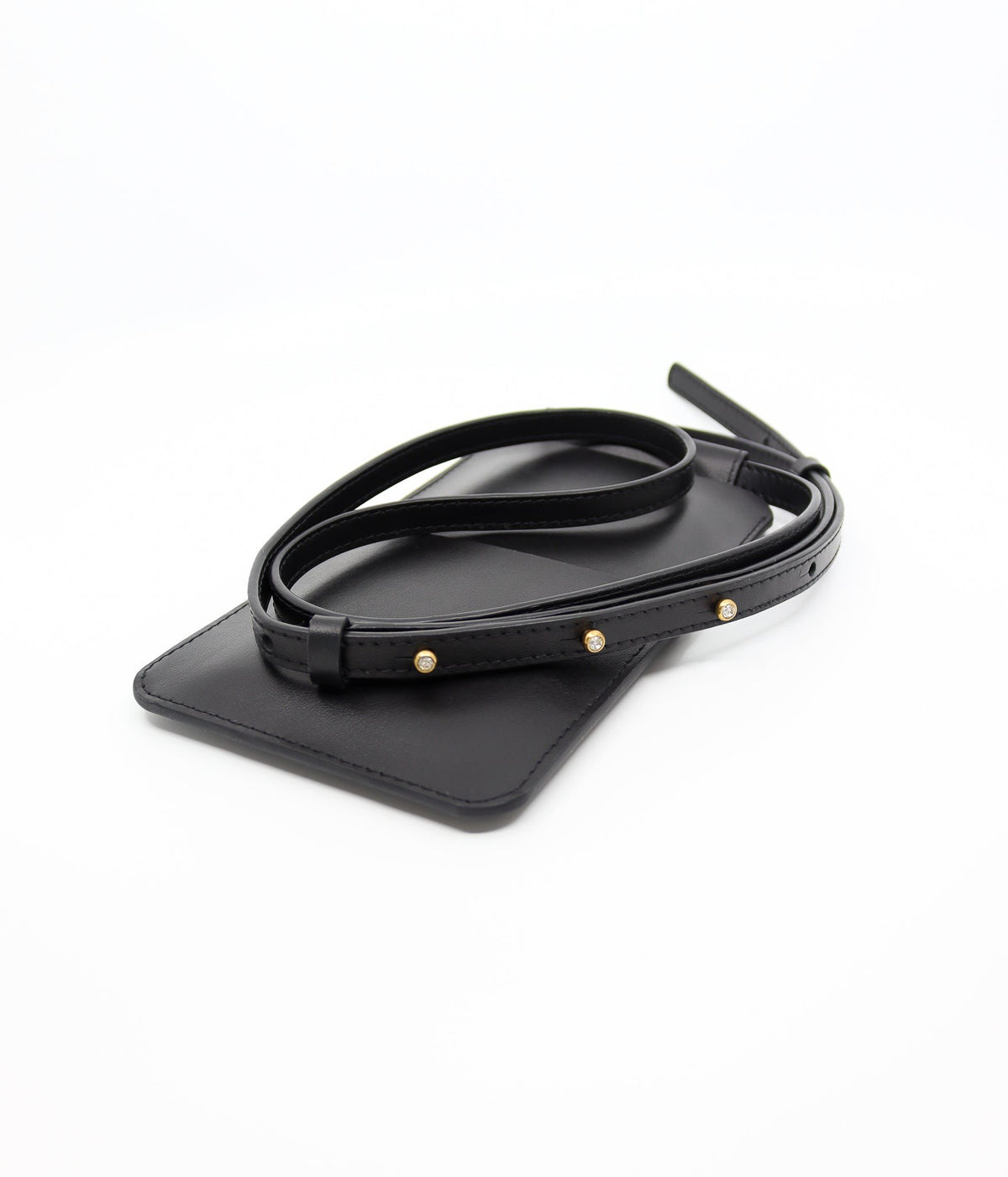5. Close-up of Tairi Roosve black leather phone bag with gold Sam Browne buttons on strap