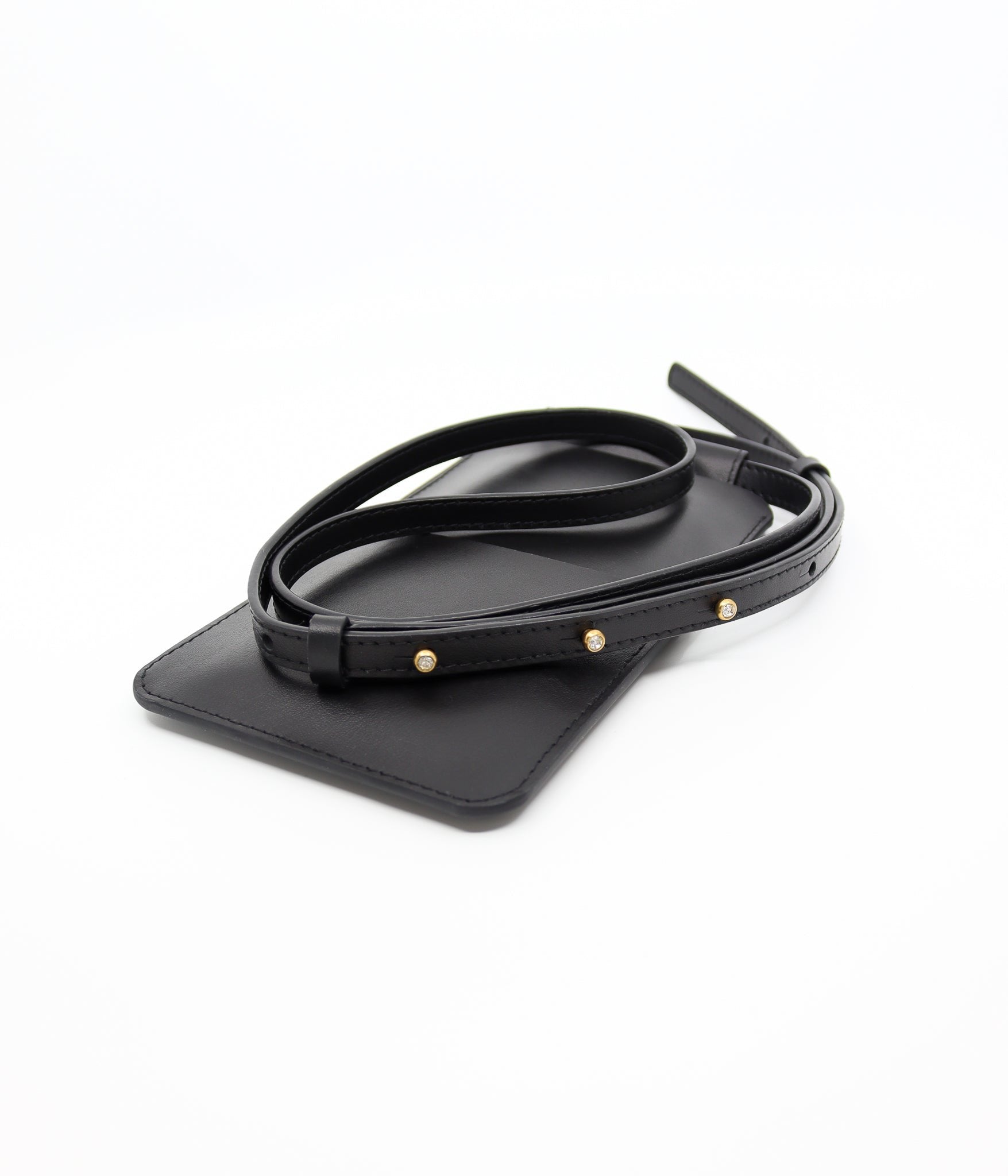 5. Close-up of Tairi Roosve black leather phone bag with gold Sam Browne buttons on strap