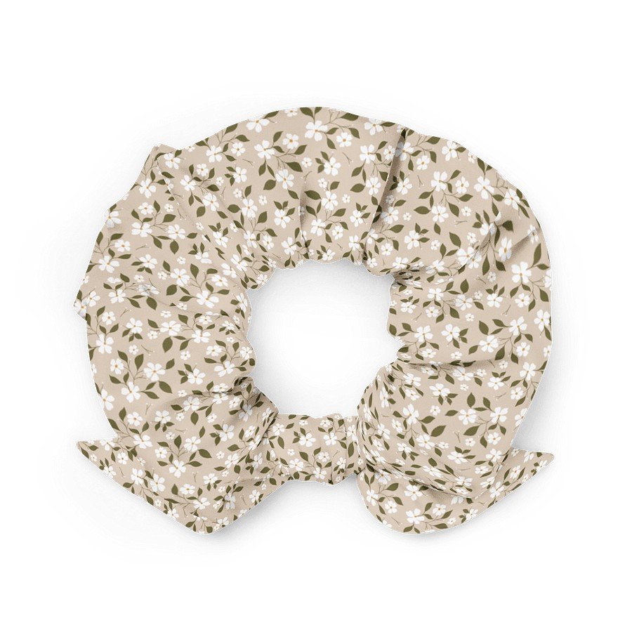 2. Beige floral scrunchie with bow detail, crafted from eco-friendly recycled polyester, displayed in a flat lay on a white background