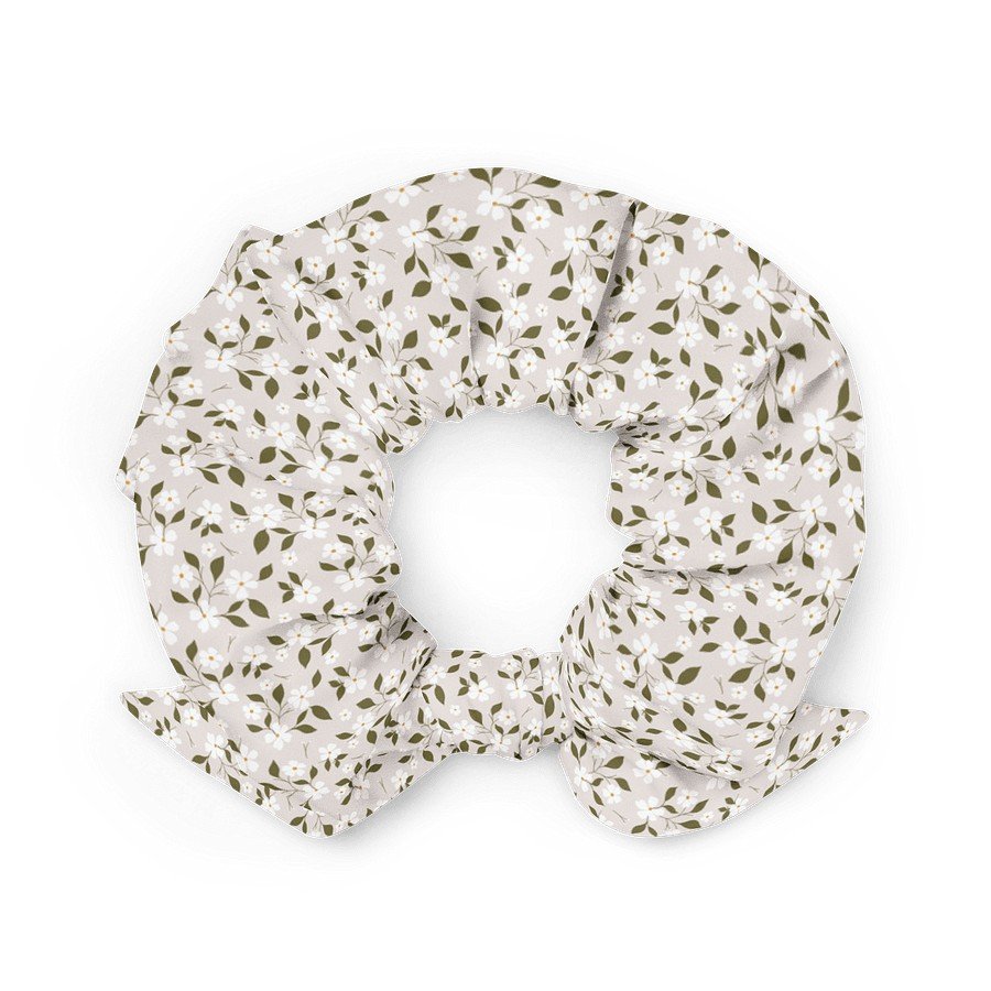 2. Beige floral scrunchie with bow detail, crafted from eco-friendly recycled polyester, displayed in a flat lay on a white background