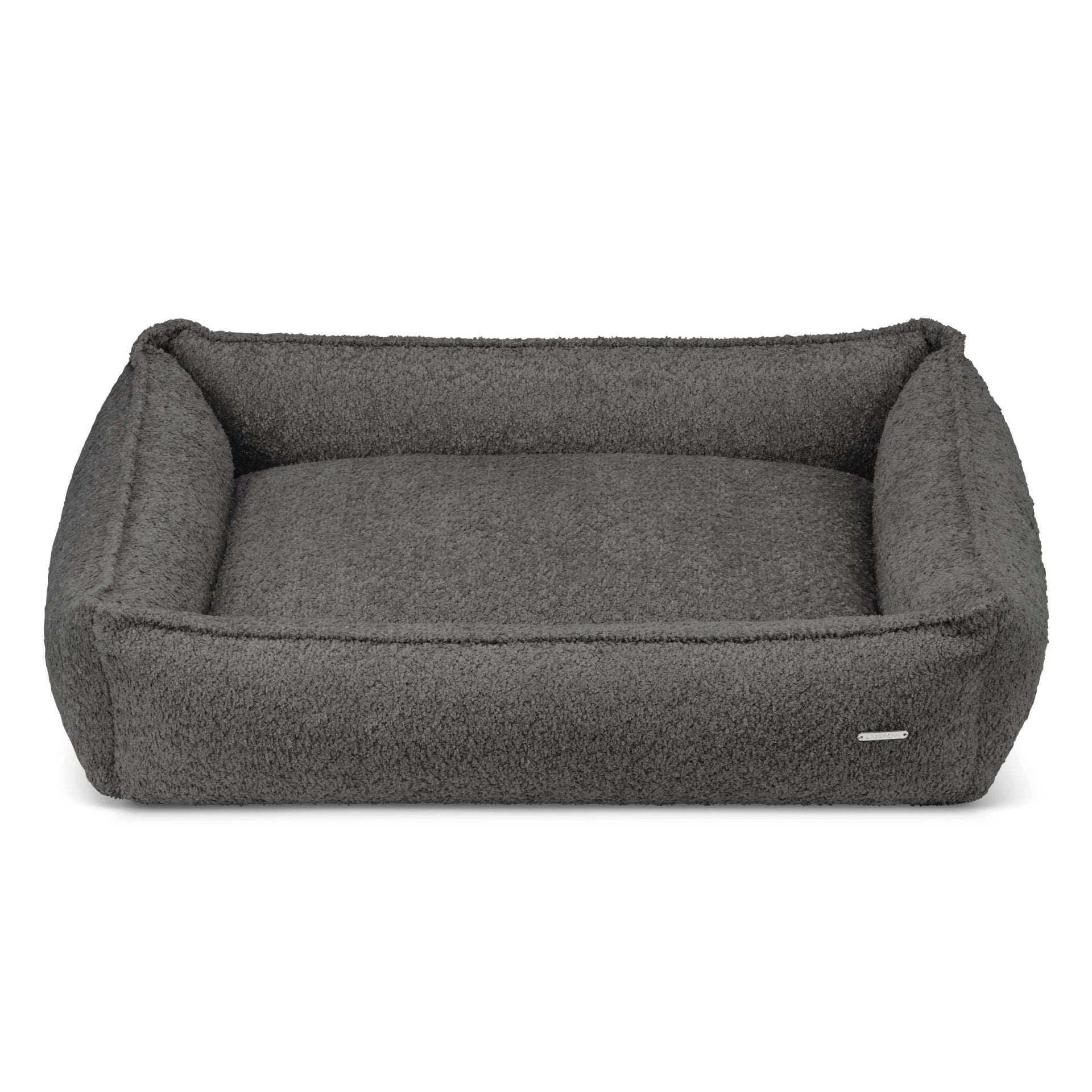 2. Anthracite boucle dog bed by Labbvenn with high sides for stability, shown in studio setting highlighting texture and design, removable cover for easy maintenance, hypoallergenic and durable materials.