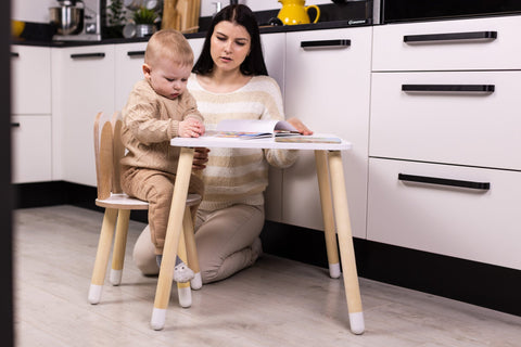 3. Mother and toddler using white bunny table and chair set in modern kitchen