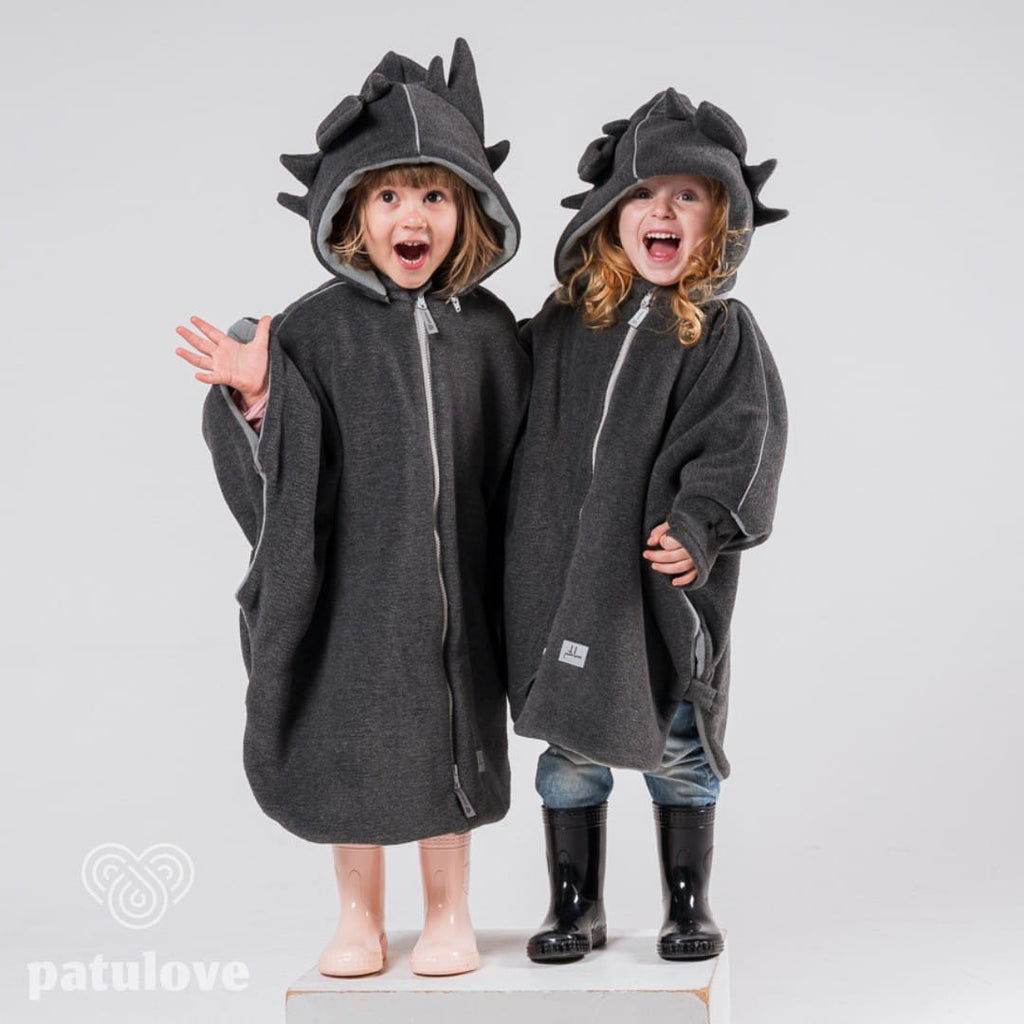 4. Two children wearing Patulove dragon-themed car ponchos with hoods, standing side by side in studio setting