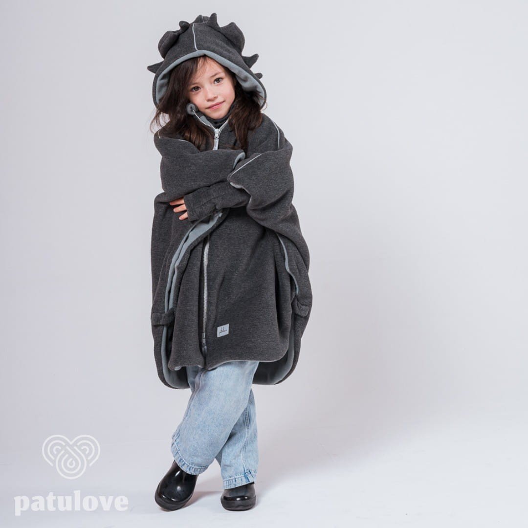 2. Girl in Patulove dragon-themed car poncho with hood, standing with arms crossed in studio setting