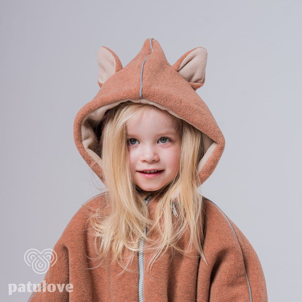 6. Girl in Patulove fox car poncho with hood, showing front view and smiling in studio