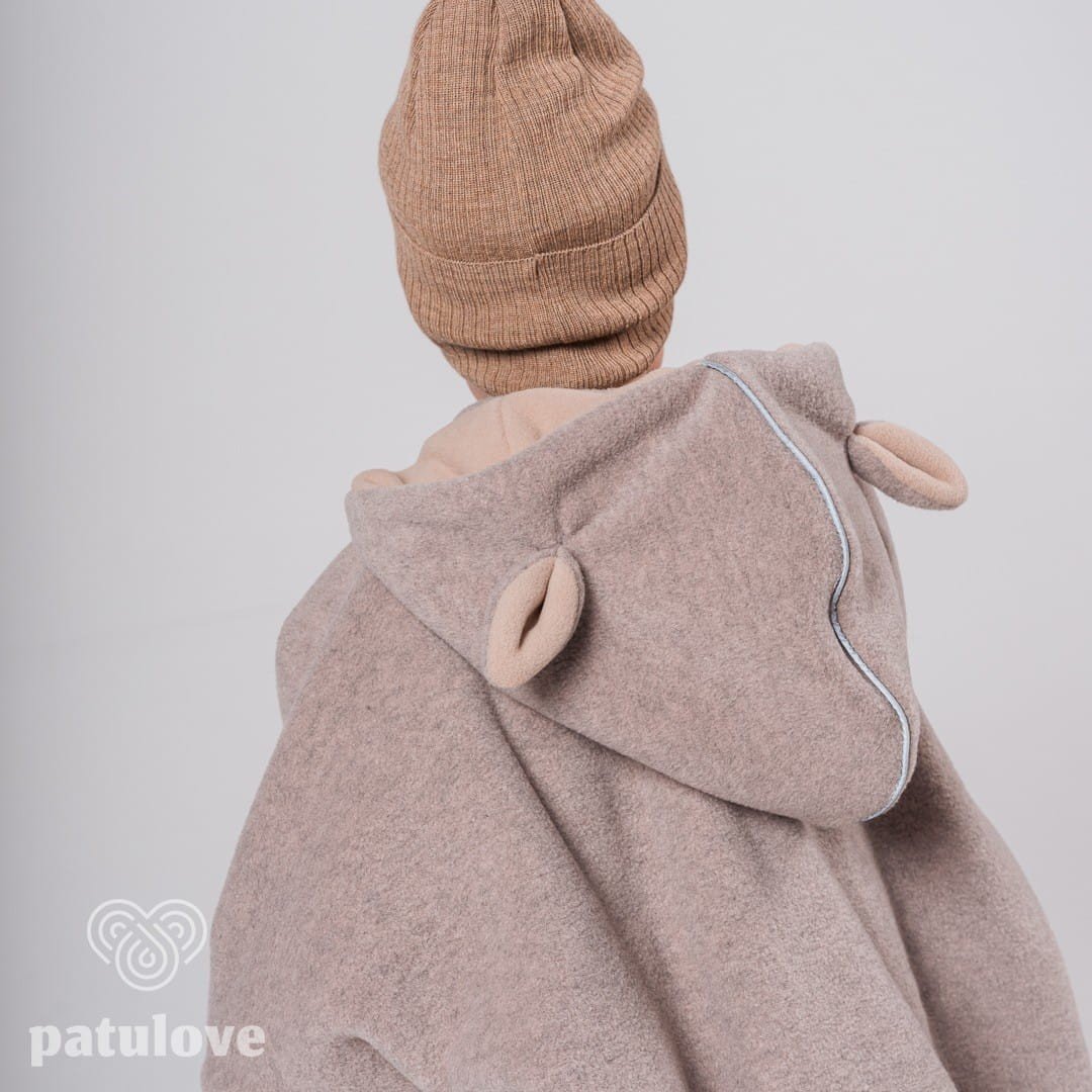 3. Back view of Patulove lamb beige car poncho with hood and ear details, worn by child in studio