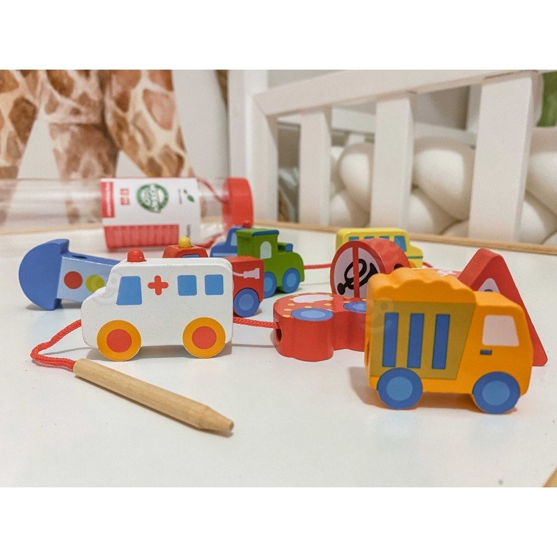 9. Close-up of wooden vehicle blocks including ambulance and traffic signs on a table