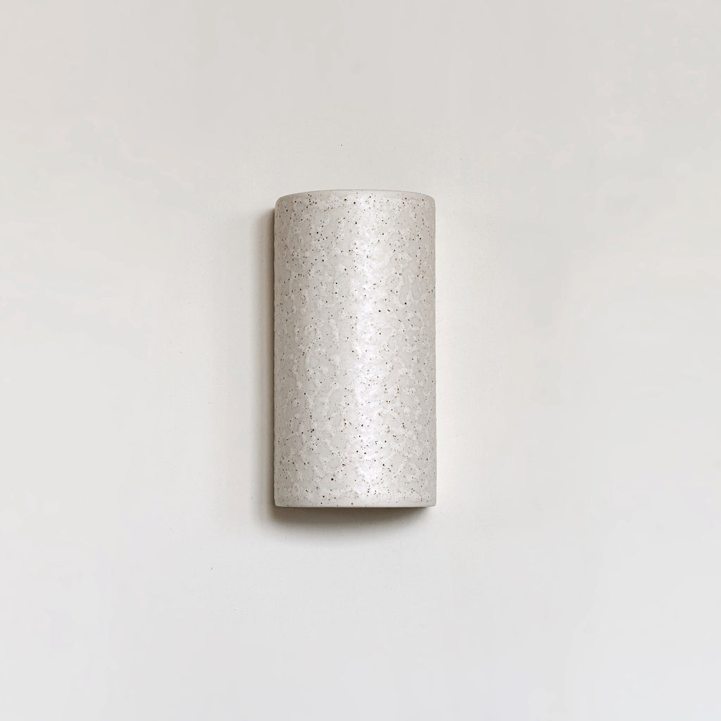 2. Beige spotted brown ceramic wall sconce with minimalist design on plain background