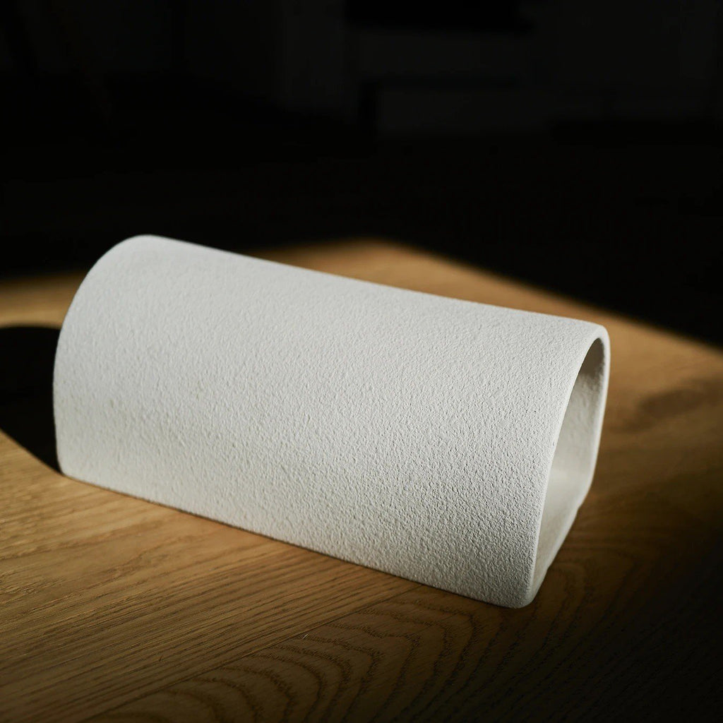 3. Close-up of extra matte white textured ceramic wall light by Ora, highlighting texture in natural light.