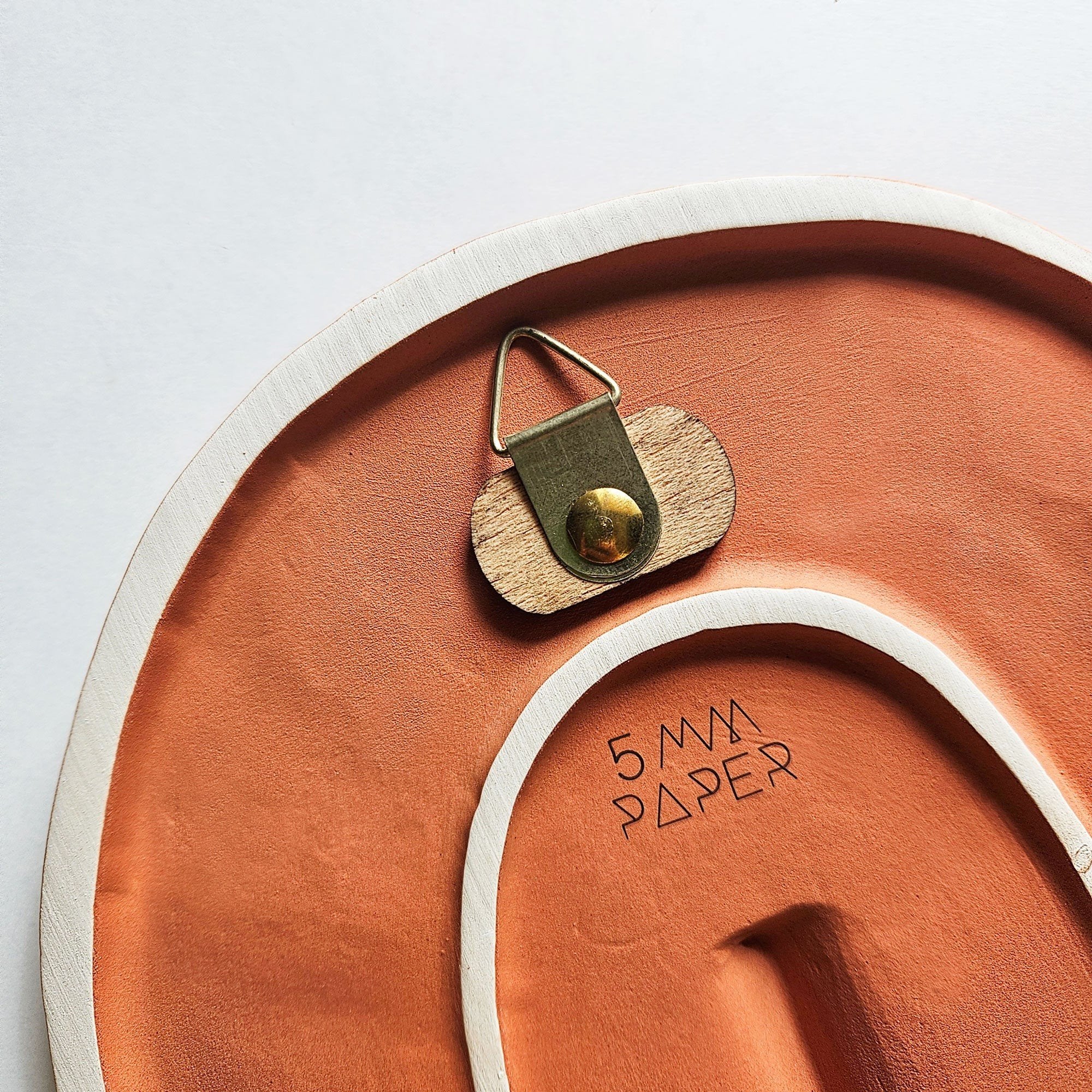 8. Back view of 5mm Paper ceramic wall mask showing hanging mechanism and brand logo