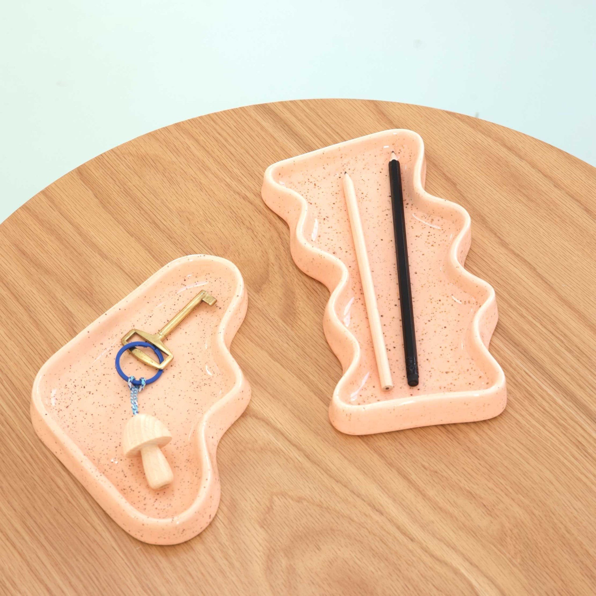 3. Close-up of Ceramic Wave Tray in peach triangle design with keys and chopsticks, showing speckled finish
