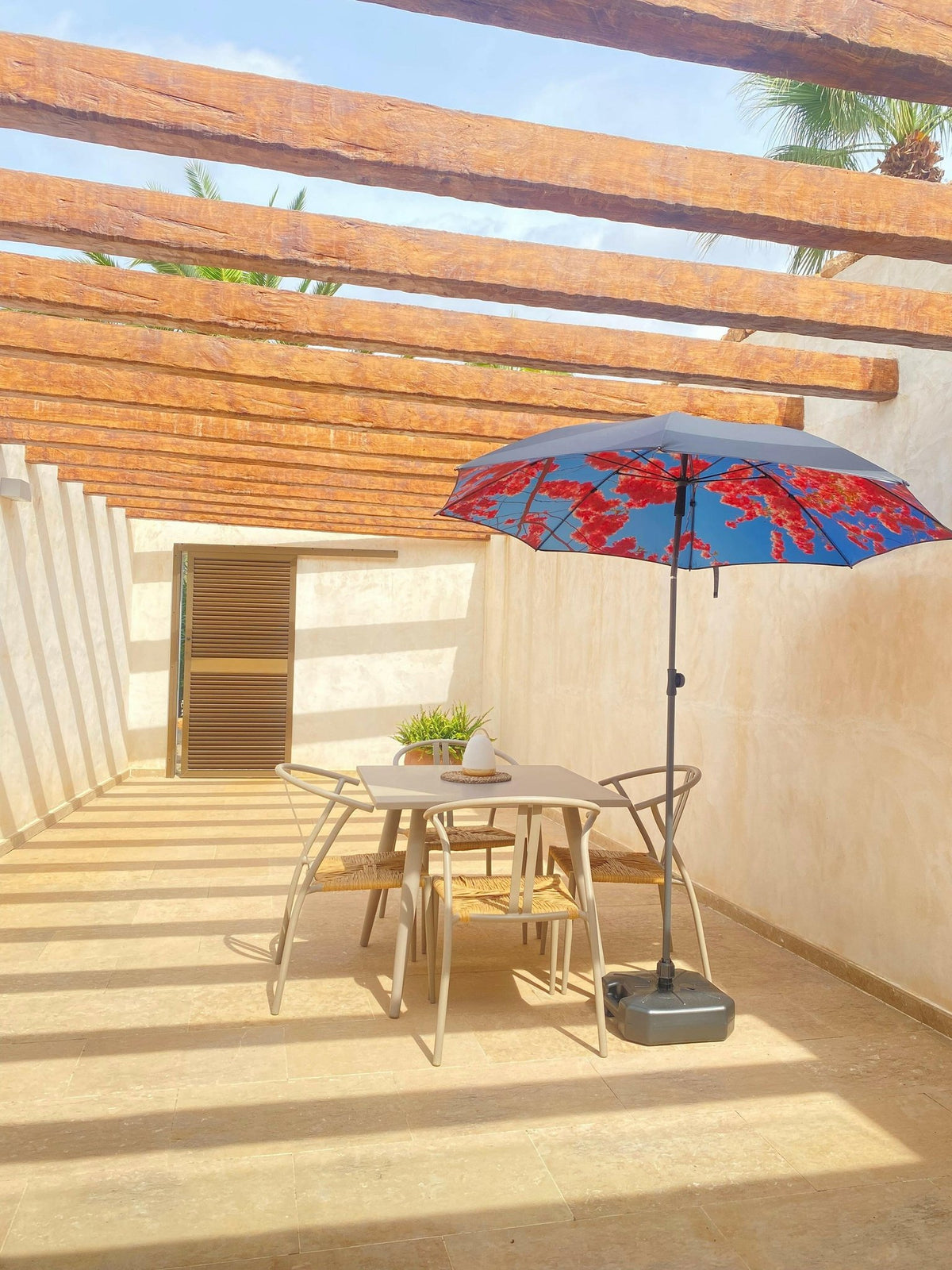 1. Cherry beach and terrace parasol with red floral print on a terrace with wooden beams and outdoor furniture