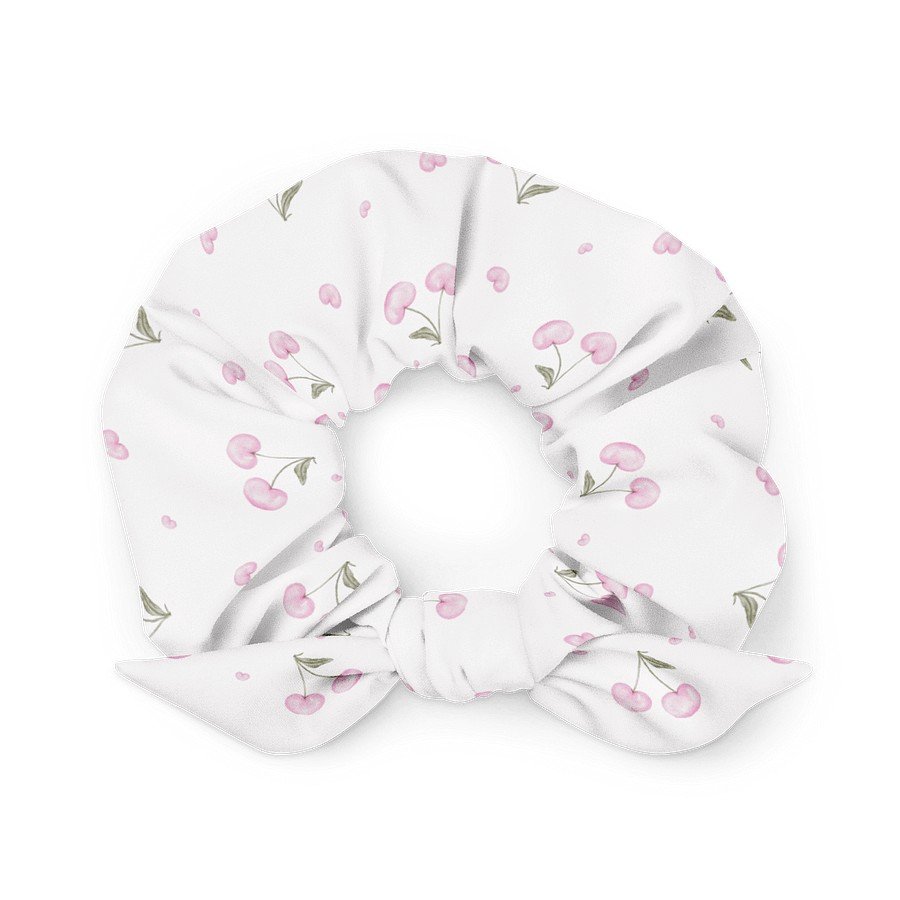 1. White scrunchie with pink cherry blossom print and bow detail, made from recycled polyester, shown in a flat lay