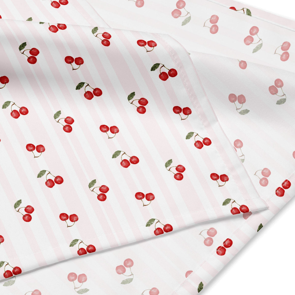 3. Close-up of cherry-patterned fabric with red cherries and green leaves on white background