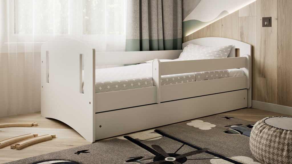 1. White children's bed with star-patterned bedding in a cozy room with natural light