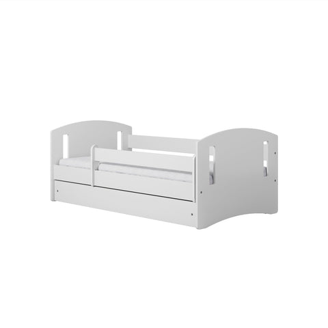 2. White children's bed with guardrail and rounded edges shown from side in studio
