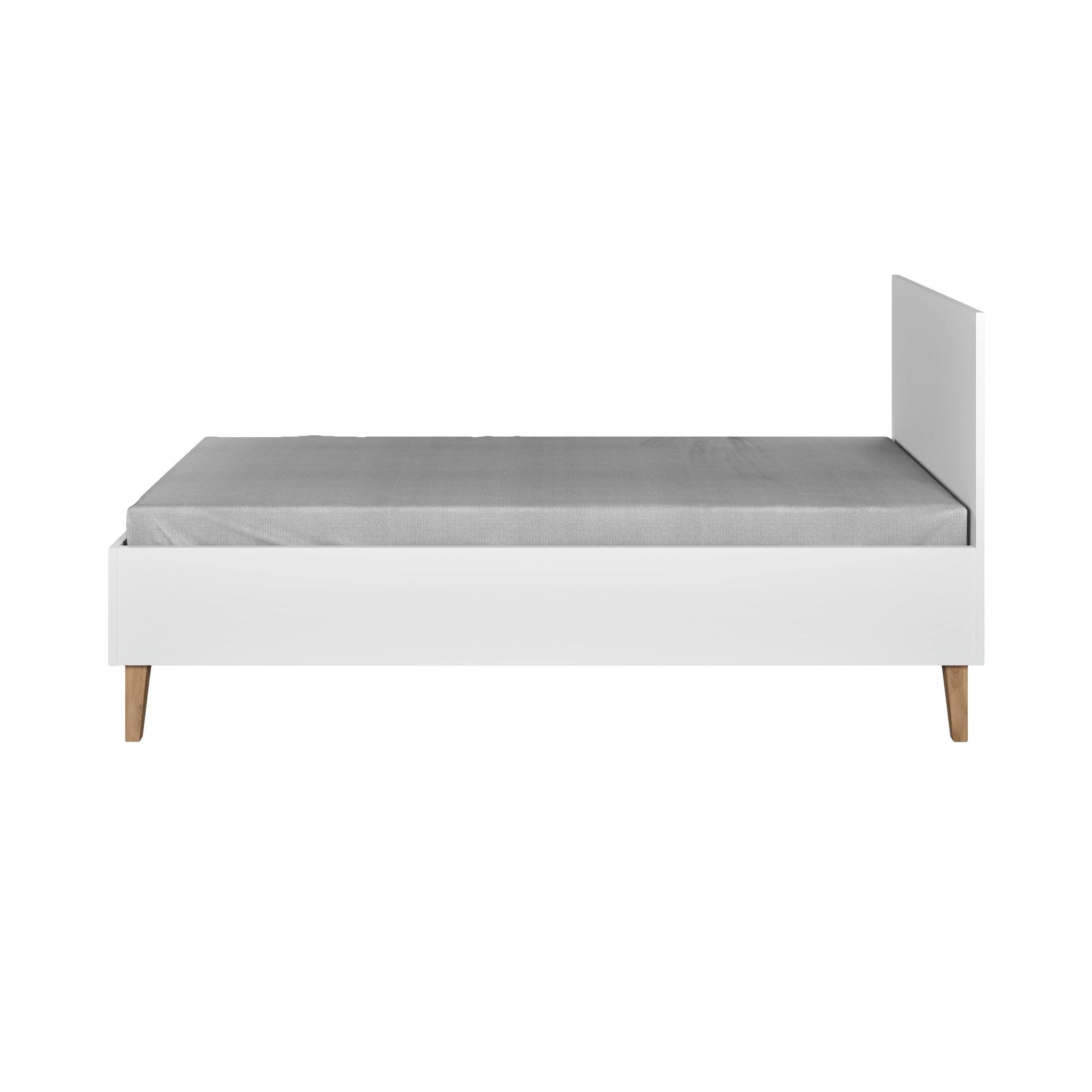 2. Side view of white Kubi children's bed with grey mattress and oak legs in a studio setting