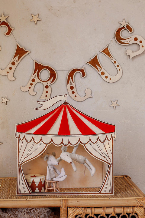 2. Red and white circus puppet theater wall decoration with plush toys inside, set against a wall with circus-themed decor